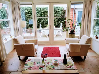 a living room with two chairs and a table at La Veranda in Zandvoort