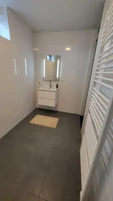 a bathroom with a sink and a mirror at B&B Kopwest 8 personen in Purmerend