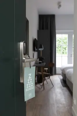a room with a door with a sign on it at Eye Hotel in Utrecht