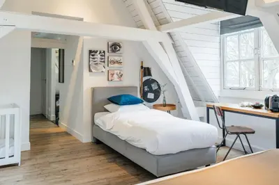 a bedroom with a bed and a desk at Eye Hotel in Utrecht