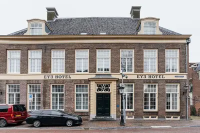 a building with a car parked in front of it at Eye Hotel in Utrecht