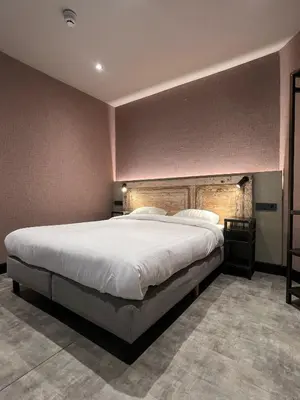 a large bedroom with a large white bed in it at Amigo Hotel in Amsterdam
