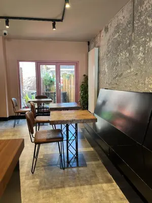a dining room with a wooden table and chairs at Amigo Hotel in Amsterdam