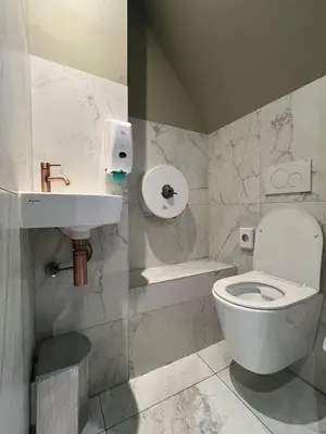 a bathroom with a white toilet and a sink at Amigo Hotel in Amsterdam