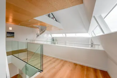 a room with white walls and a ceiling with skylights at Villa Beachhouse in Bergen aan Zee