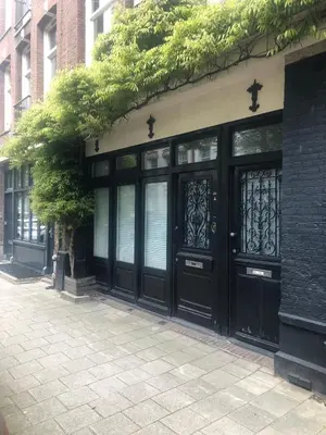a pair of black doors on a building at Quartier Museum Center Amsterdam in Amsterdam