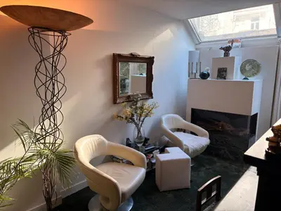 a living room with two chairs and a mirror at Quartier Museum Center Amsterdam in Amsterdam