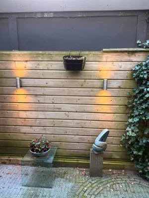 a wooden wall with a planter on top of it at Quartier Museum Center Amsterdam in Amsterdam