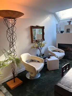 a living room with two chairs and a lamp at Quartier Museum Center Amsterdam in Amsterdam