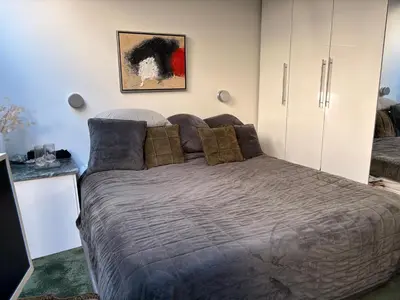 a bedroom with a bed and a painting on the wall at Quartier Museum Center Amsterdam in Amsterdam