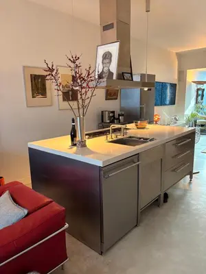 a kitchen with a kitchen island with a sink and a counter at Quartier Museum Center Amsterdam in Amsterdam