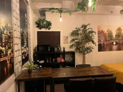 a dining room with a table and some plants at The Studio no windows 20 minutes by bus to downtown Amsterdam in Purmerend