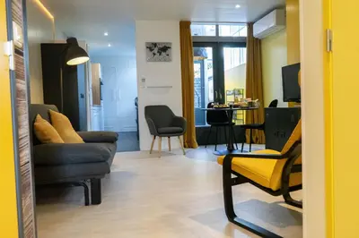 a living room with a couch and a chair at B&B Sunflower Leiden in Leiden