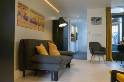 a living room with a couch and a chair at B&B Sunflower Leiden in Leiden