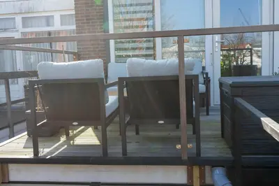 two chairs and a table on a balcony at B&B Sunflower Leiden in Leiden