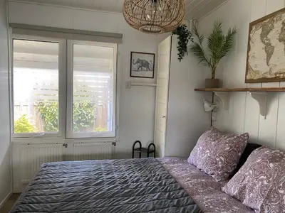 a bedroom with a bed and a window at Chalet Goodmorning in Dirkshorn