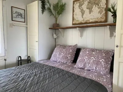 a bedroom with a bed with purple pillows at Chalet Goodmorning in Dirkshorn