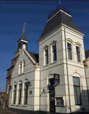 a building with a steeple on top of it at Hart van Warder in Warder