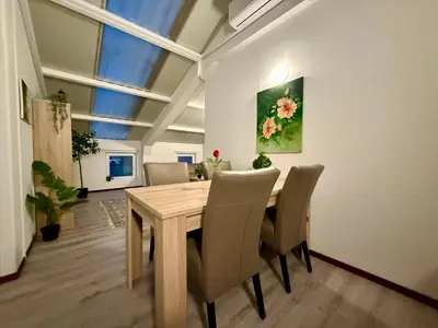a dining room with a wooden table and chairs at Holiday Home Vijfhuizen in Vijfhuizen