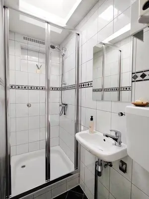 a bathroom with a tub and a sink and a shower at Beleef Noordwijk strandhuisje in Noordwijk aan Zee