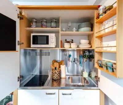 a small kitchen with a sink and a microwave at Boutique at the beach in Zandvoort