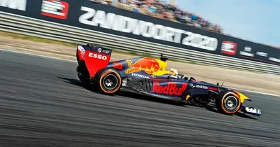 a racing car is speeding down a race track at Boutique at the beach in Zandvoort
