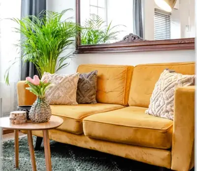 a brown couch in a living room with a table at Boutique at the beach in Zandvoort