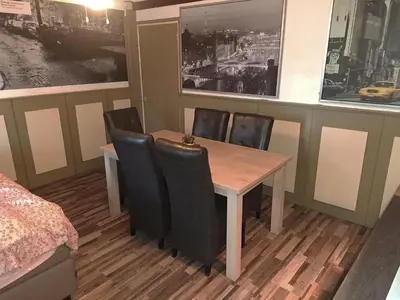 a dining room with a table and chairs at Slotje in Egmond aan den Hoef