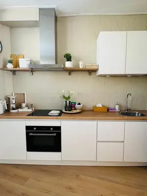 a kitchen with white cabinets and a sink at Casa Camino Del Mar 40 in Noordwijk aan Zee