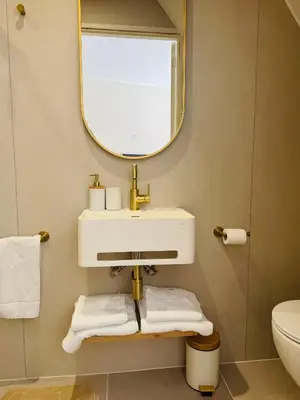 a bathroom with a sink and a mirror at Casa Camino Del Mar 40 in Noordwijk aan Zee