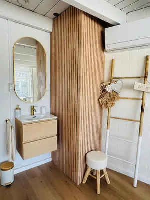 a bathroom with a sink and a mirror and a stool at Casa Camino Del Mar 40 in Noordwijk aan Zee
