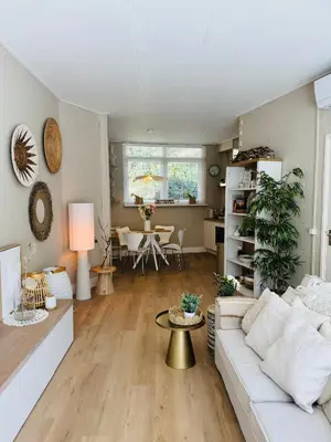 a living room with a white couch and a table at Casa Camino Del Mar 40 in Noordwijk aan Zee