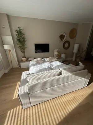 a bedroom with a large bed in a room at Casa Camino Del Mar 40 in Noordwijk aan Zee