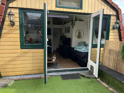 a house with a door open to a patio at Comfortabel studio 19 min from downtown Amsterdam in Purmerend