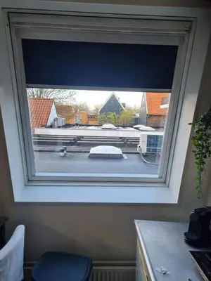 a window with a view of a parking lot at Comfortabel studio 19 min from downtown Amsterdam in Purmerend
