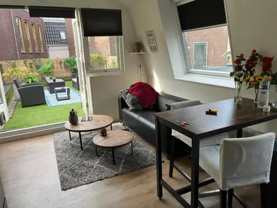 a living room with a couch and a table at Comfortabel studio 19 min from downtown Amsterdam in Purmerend