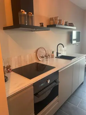 a kitchen with a sink and a counter at Zon & blij in Katwijk aan Zee