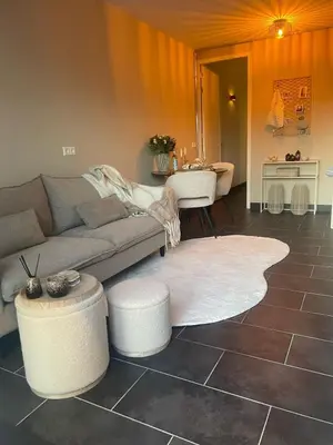 a living room with a couch and a table at Zon & blij in Katwijk aan Zee