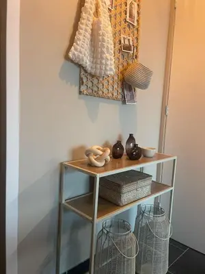 a shelf in a room with baskets on the wall at Zon & blij in Katwijk aan Zee