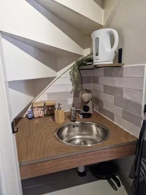 a sink in a small room with a staircase at Bed & Breakfast De Punt in Monnickendam