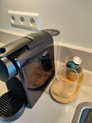 a toaster sitting on a kitchen counter with two cups at Blom studio's in Hillegom