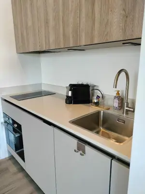 a small kitchen with a sink and a microwave at Blom studio's in Hillegom