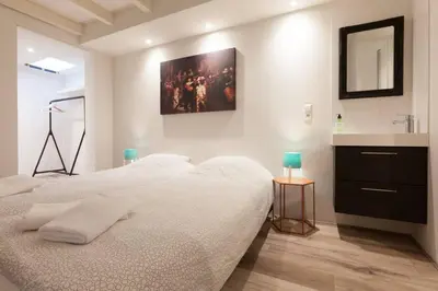 a bedroom with a white bed and a sink at Lovely 4P-apt near Canals - Utrecht City Centre in Utrecht