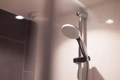 a shower with a blow dryer in a bathroom at Lovely 4P-apt near Canals - Utrecht City Centre in Utrecht