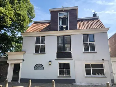 a white house with a brown roof at Lovely 4P-apt near Canals - Utrecht City Centre in Utrecht