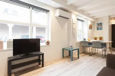 a living room with a flat screen tv on a table at Lovely 4P-apt near Canals - Utrecht City Centre in Utrecht