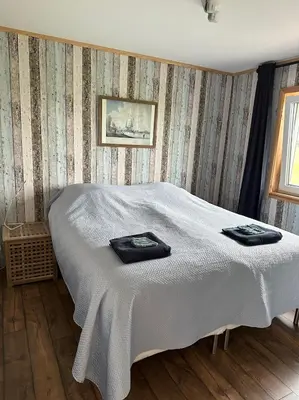 a bedroom with a bed with two towels on it at BB Saari in De Woude