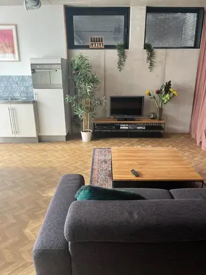 a living room with a couch and a coffee table at Wellness Appartement Duinpoort in Castricum