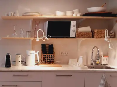 a kitchen counter with a sink and a microwave at studio Le Garage in Bergen