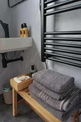 a pile of towels on a wooden table in a bathroom at 1 aan Strand in Egmond aan Zee